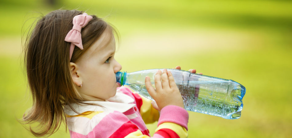 little girl drinks mineral water