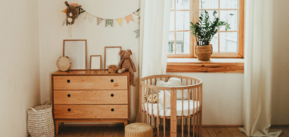Scandinavian style children's room interior. A cozy oval baby bed (cradle). Home Sweet Home.
