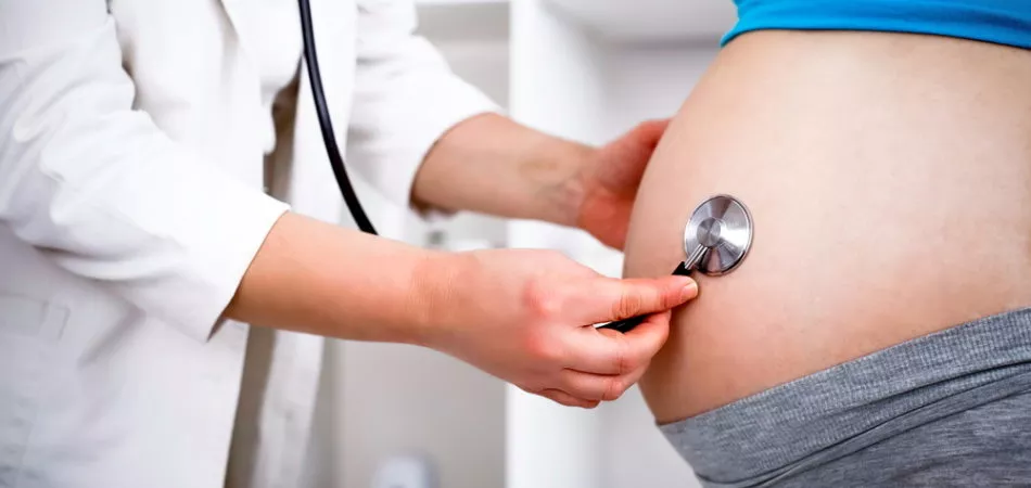 Pregnant woman in the doctor's office. She has a prenatal check up.